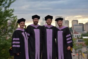 Dr. Mike and his roommates dental school graduation photo overlooking Richmond VA skyline.
