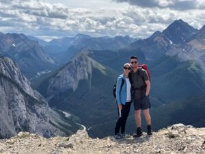 two hikers with mountains in the background