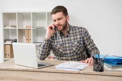 man scheduling a dental appointment at Uptown Family Dental