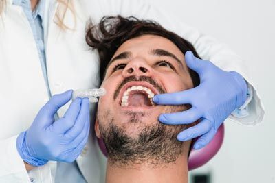 patient being fitted for new clear orthodontic aligners