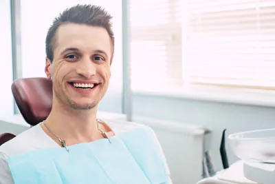 man smiling during his dental appointment at Uptown Family Dental