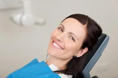 woman showing off her restored smile thanks to services from Uptown Family Dental